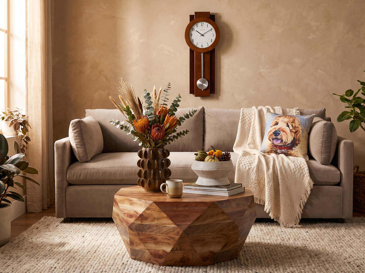 Living room vignette with wall clock, sofa pillows, jute rug and a golden retriever